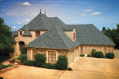Orange brick home with dark GAF roofing