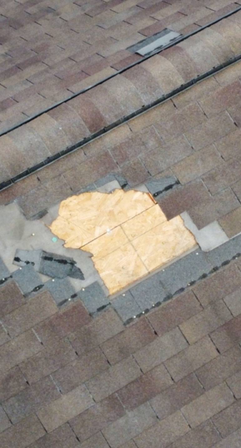 Damaged shingles from a storm - aerial view