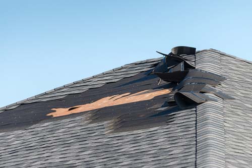 Wind damaged roof shingles