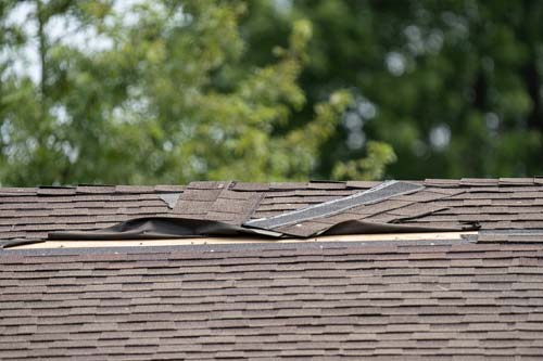 Damaged shingles ripped up